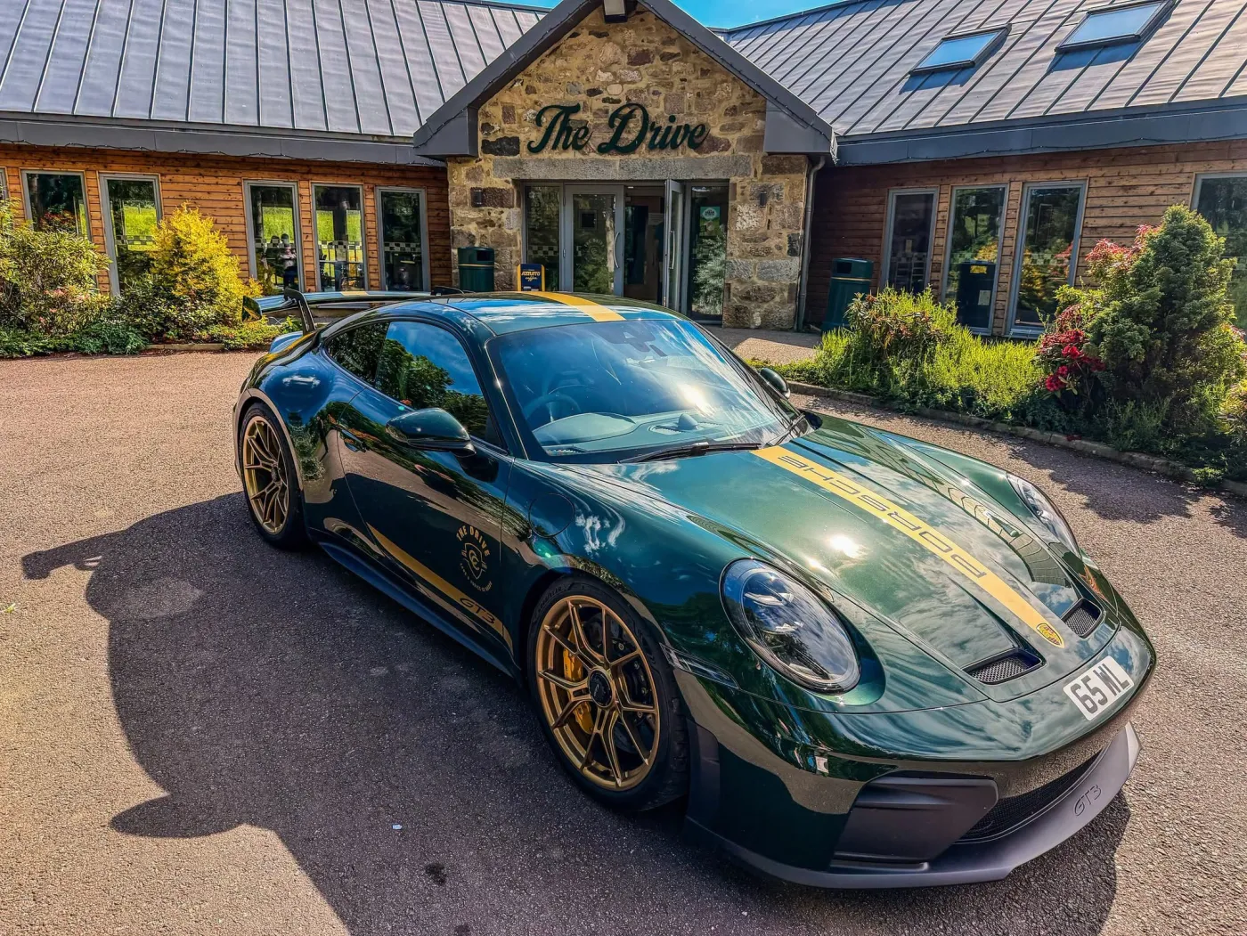 A green Porsche 911 GT3 in The Drive at Haddo livery outside the café, car meets in Aberdeenshire
